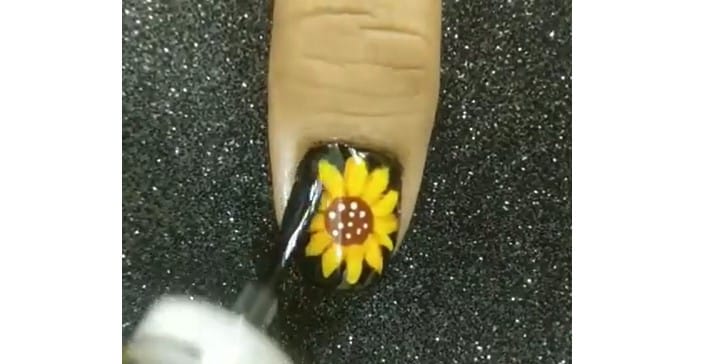 Sunflower Nail Designs: Step 4, to lock in your swirls apply two layers of top coat, for a shiny, gel-like finish
