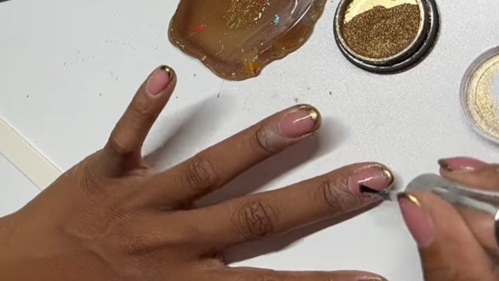 Gold French Manicure: Step 6, finish with a thin layer of a shiny topcoat
