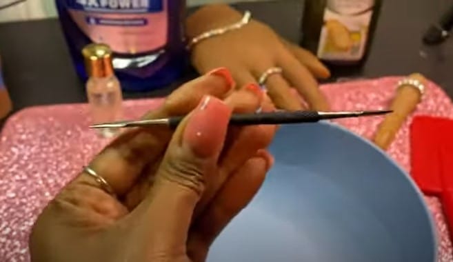 How To Remove Dip Nails Without Acetone: Step 1, use a cuticle pusher or a nail tip to gently push underneath the sides of your nails
