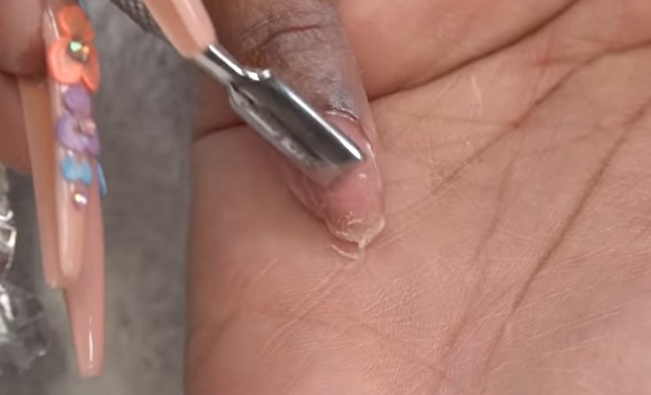 How To Remove Polygel Nails: Step 3, use a clean cuticle pusher to remove the rest of the polygel
