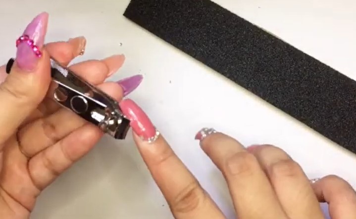 How To Remove Polygel Nails: Step 1, trim the nail carefully, removing any soft or brittle extra length
