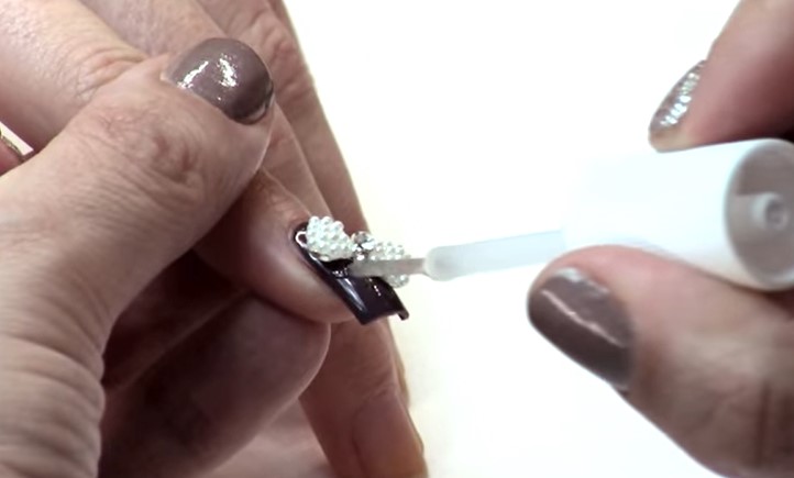 Nail Charms: Step 4, apply a clear top coat to give the jewels extra staying power
