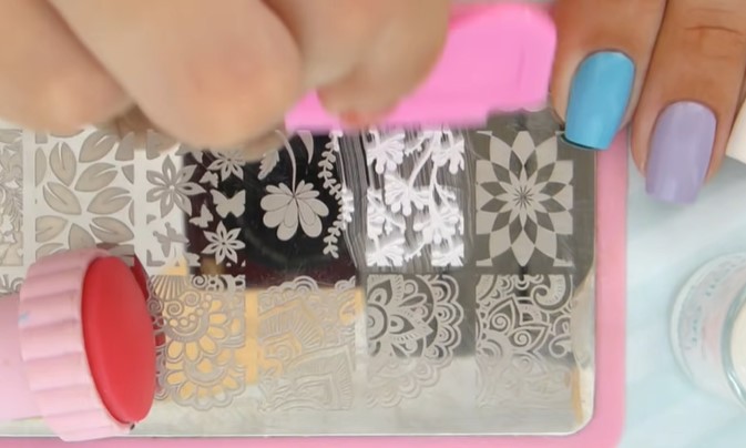 Best Nail Stamp Kit: Step 4, remove excess polish using a scraper
